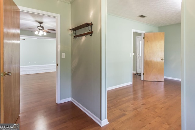 1114 Laurel St, Blackshear, GA 31516 - hallway with crown molding, baseboards, visible vents, and wood finished floors