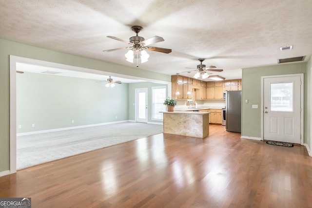 1114 Laurel St, Blackshear, GA 31516 - kitchen with freestanding refrigerator, baseboards, light countertops, and visible vents