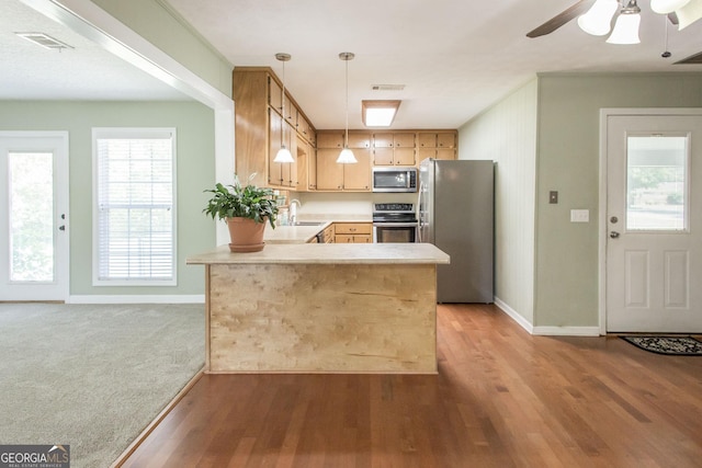 1114 Laurel St, Blackshear, GA 31516 - kitchen with a sink, a peninsula, visible vents, light countertops, and appliances with stainless steel finishes
