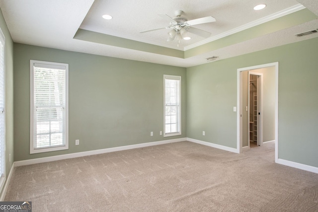 1114 Laurel St, Blackshear, GA 31516 - carpeted empty room with ornamental molding, a healthy amount of sunlight, visible vents, ceiling fan, and a raised ceiling