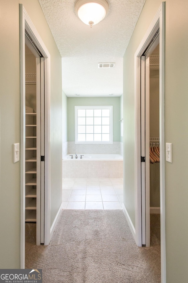 1114 Laurel St, Blackshear, GA 31516 - hall featuring carpet, a textured ceiling, and visible vents