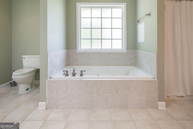 1114 Laurel St, Blackshear, GA 31516 - bathroom featuring toilet, a garden tub, and tile patterned floors
