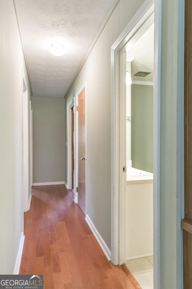 1114 Laurel St, Blackshear, GA 31516 - hallway featuring ornamental molding, baseboards, and wood finished floors