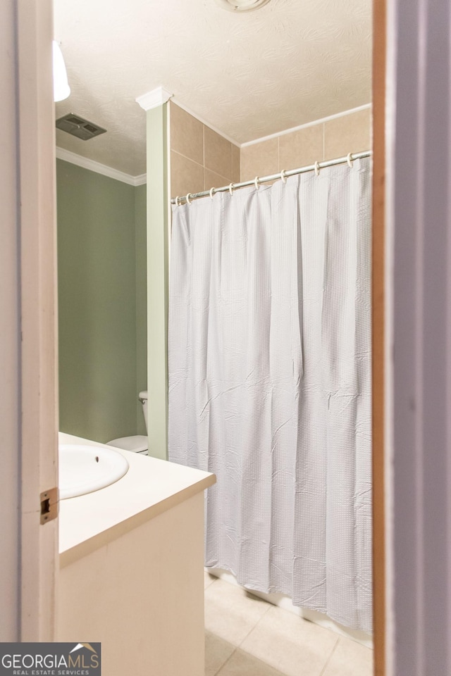 1114 Laurel St, Blackshear, GA 31516 - bathroom featuring ornamental molding, visible vents, curtained shower, tile patterned flooring, and vanity