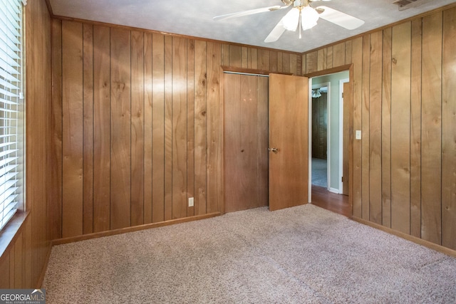 1114 Laurel St, Blackshear, GA 31516 - unfurnished bedroom with carpet, wooden walls, and ceiling fan