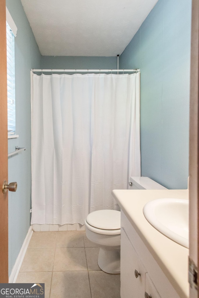 1114 Laurel St, Blackshear, GA 31516 - full bathroom with vanity, toilet, a shower with curtain, and tile patterned floors