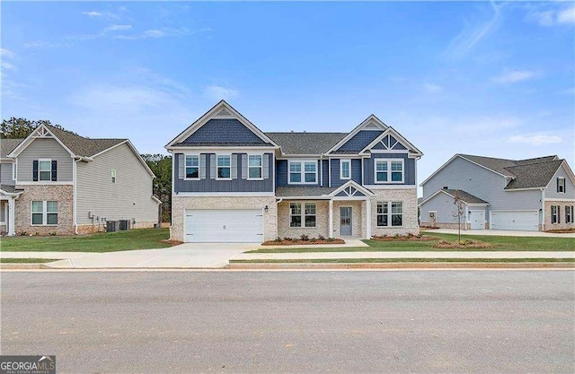 512 Dolce Rd, Locust Grove, GA 30248 - craftsman house with concrete driveway, a garage, and a front lawn