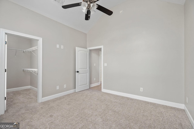 unfurnished bedroom featuring high vaulted ceiling, baseboards, and carpet floors