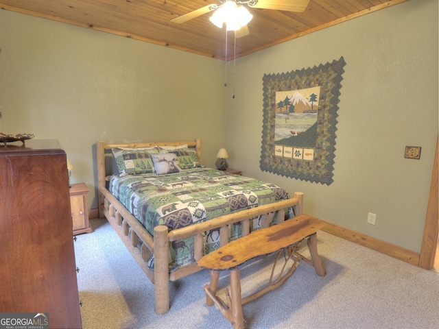 bedroom featuring wooden ceiling, carpet flooring, and a ceiling fan
