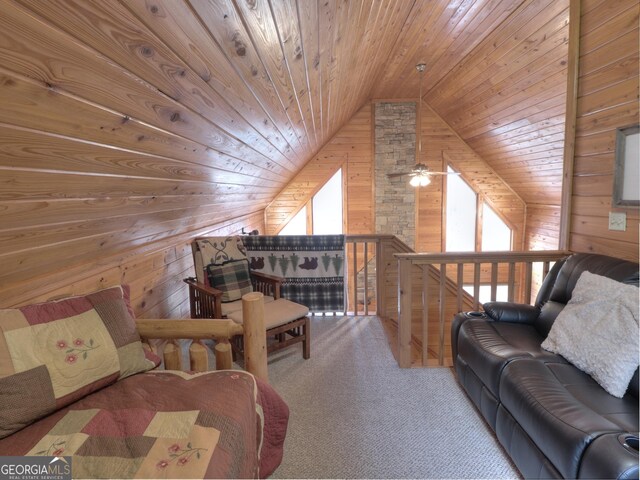 living area with lofted ceiling, wooden walls, wood ceiling, and carpet floors