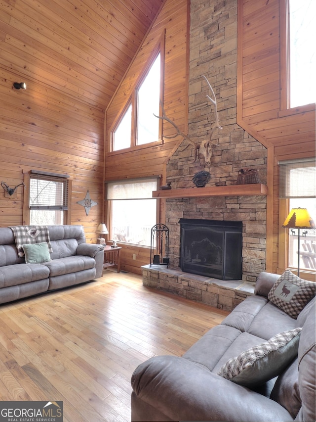 living room featuring a wealth of natural light, hardwood / wood-style flooring, and high vaulted ceiling