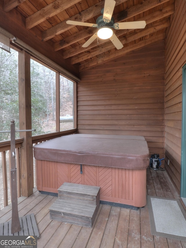 sunroom with a ceiling fan, beamed ceiling, and a jacuzzi