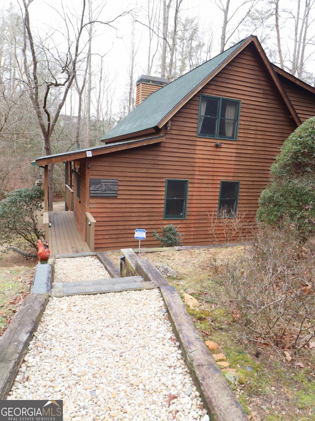 view of side of home with a chimney