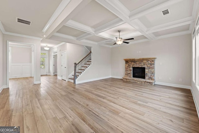 unfurnished living room with stairs, a ceiling fan, visible vents, and beam ceiling