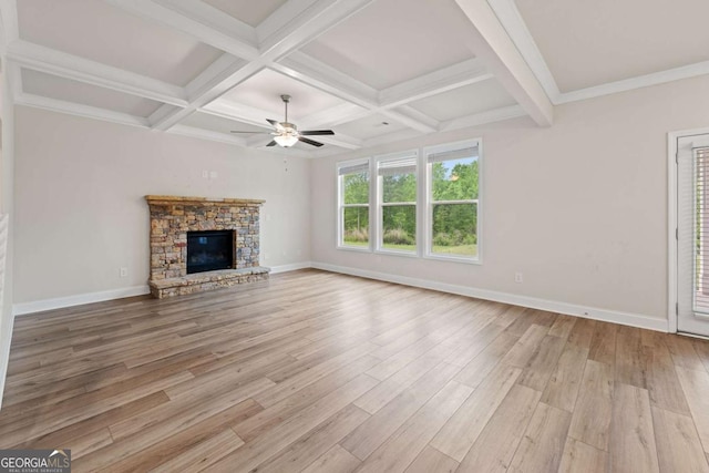 unfurnished living room with coffered ceiling, light wood-style flooring, a ceiling fan, and beamed ceiling