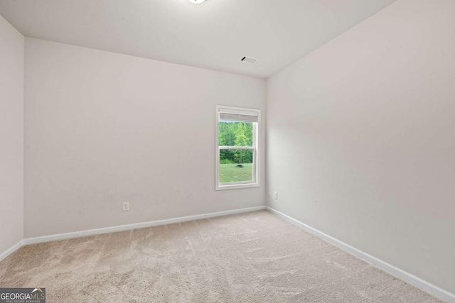 unfurnished room featuring baseboards, visible vents, and carpet floors