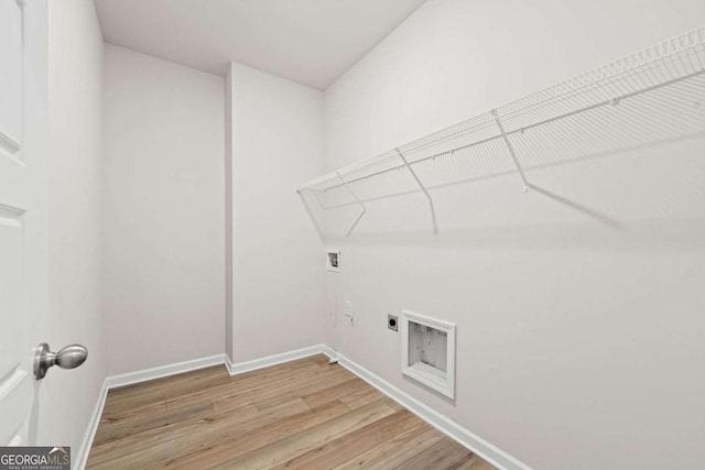 laundry area featuring baseboards, washer hookup, hookup for an electric dryer, light wood-style floors, and laundry area
