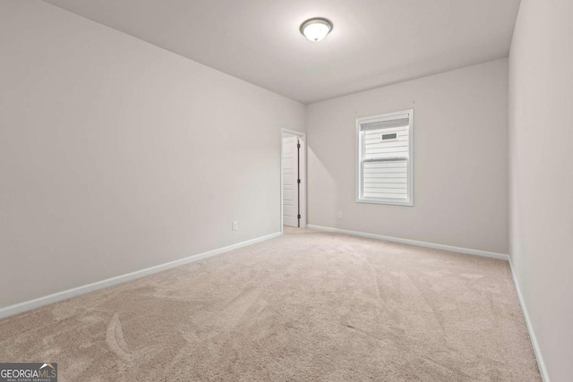 spare room with carpet floors and baseboards