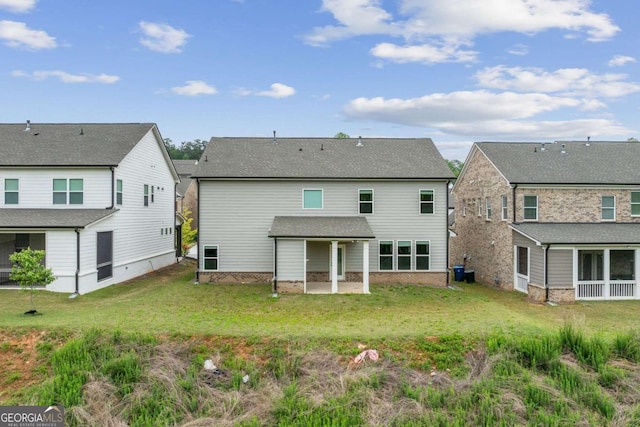 back of house with a yard, a patio, and a residential view