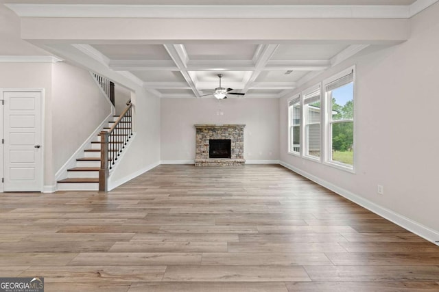unfurnished living room featuring wood finished floors, a ceiling fan, beamed ceiling, and stairs