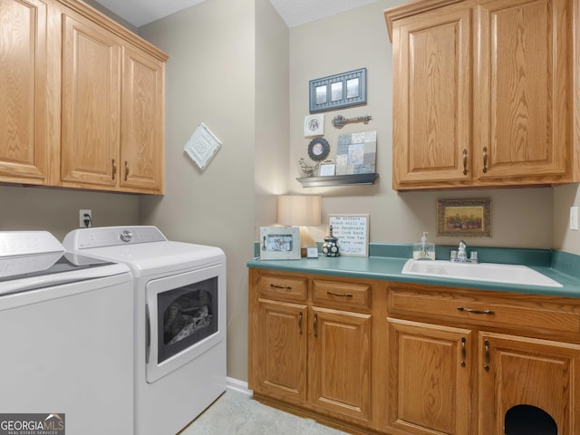 laundry area with cabinet space, washer and clothes dryer, light tile patterned flooring, and a sink