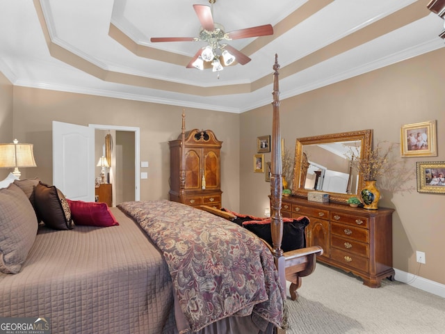 bedroom featuring baseboards, ceiling fan, crown molding, a raised ceiling, and light colored carpet