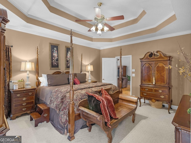 bedroom featuring crown molding, a raised ceiling, and light colored carpet