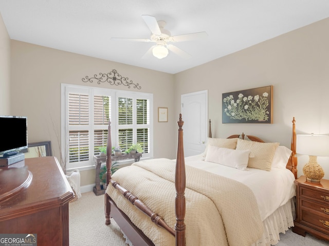 bedroom featuring light carpet, baseboards, and a ceiling fan