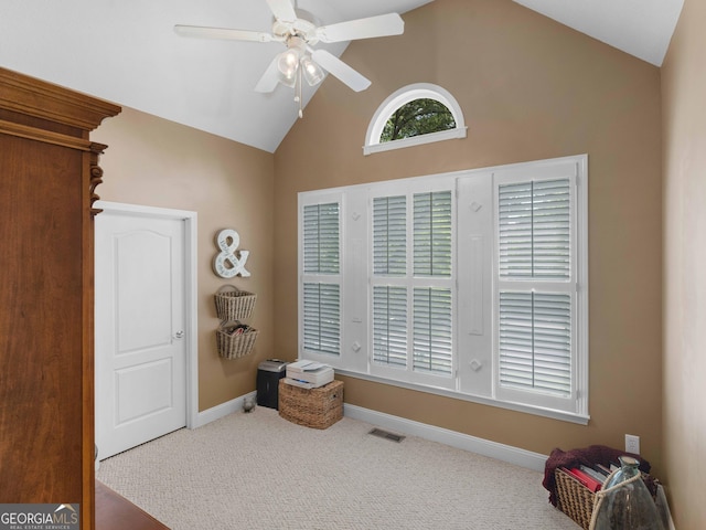 interior space featuring carpet, high vaulted ceiling, visible vents, a ceiling fan, and baseboards