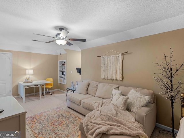 living room with a textured ceiling, visible vents, ceiling fan, carpet floors, and baseboards