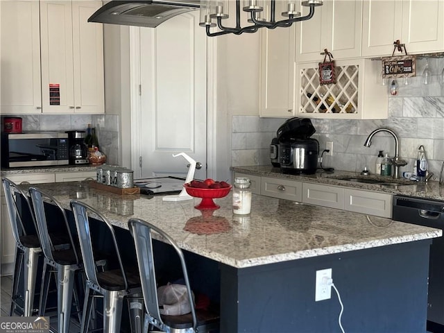 3000 Keeneland Blvd, Mcdonough, GA 30252 - kitchen featuring stainless steel microwave, dishwasher, light stone countertops, a kitchen island, and backsplash