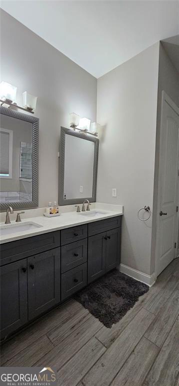 3000 Keeneland Blvd, Mcdonough, GA 30252 - bathroom featuring wood finished floors, double vanity, and baseboards
