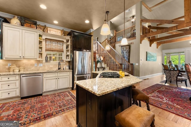 533 Birch River Dr Unit 17, Dahlonega, GA 30533 - kitchen with appliances with stainless steel finishes, a sink, a center island, tasteful backsplash, and light wood-type flooring