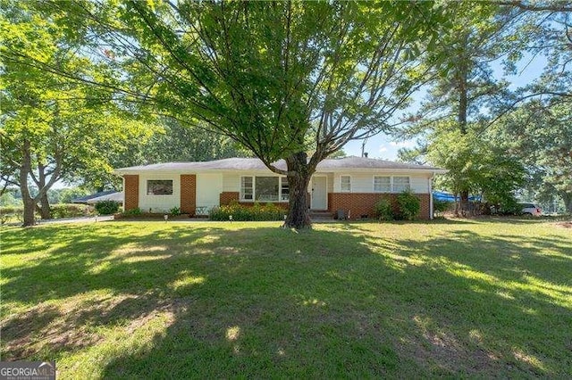single story home featuring a front lawn and brick siding