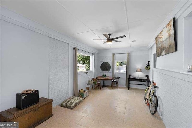 sitting room with ceiling fan and visible vents