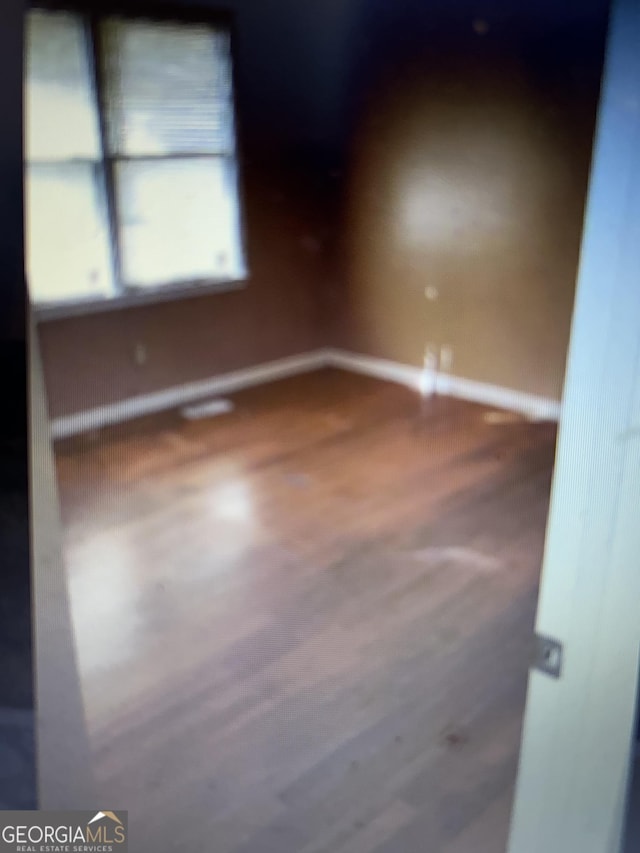 spare room featuring baseboards
