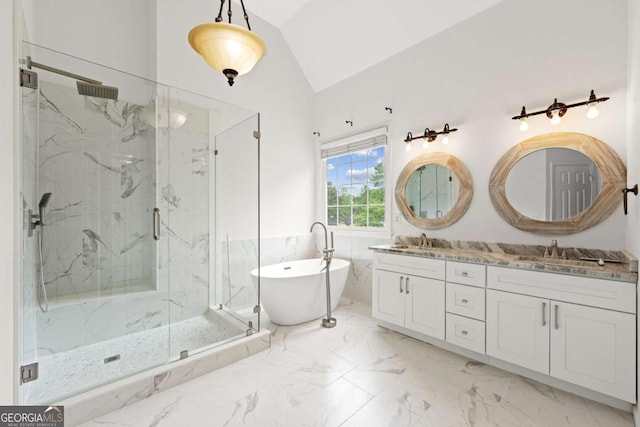 bathroom with a marble finish shower, a sink, a freestanding bath, marble finish floor, and lofted ceiling