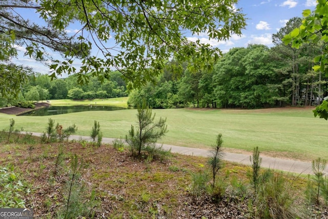 view of yard with a water view and golf course view
