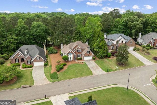 birds eye view of property with a wooded view