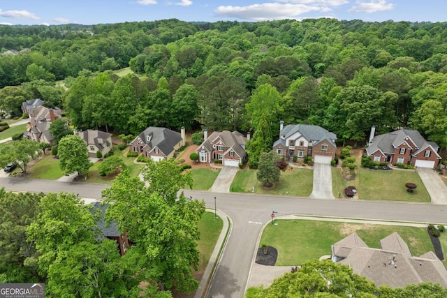 drone / aerial view with a view of trees and a residential view