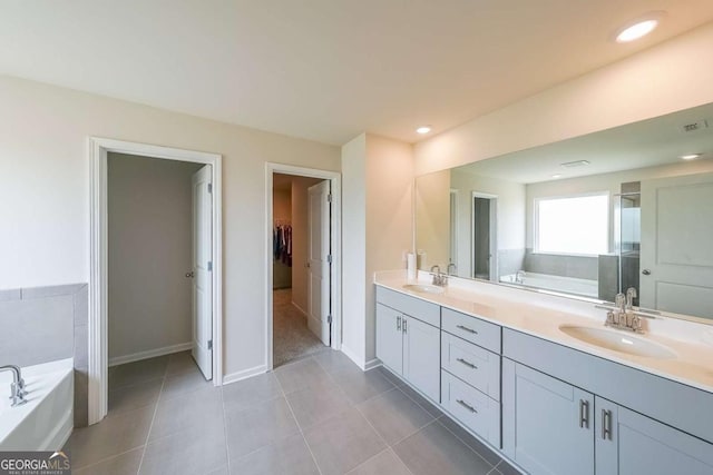 5958 Green Ash Ct, Braselton, GA 30517 - bathroom featuring a garden tub, double vanity, a spacious closet, tile patterned flooring, and a shower stall