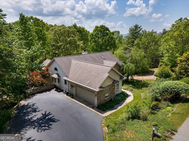 birds eye view of property featuring a view of trees