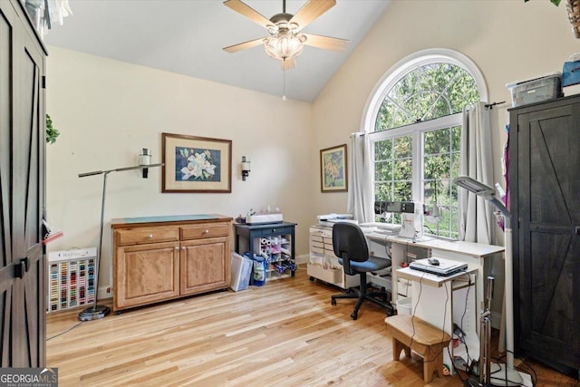 home office featuring ceiling fan, baseboards, high vaulted ceiling, and light wood-style floors