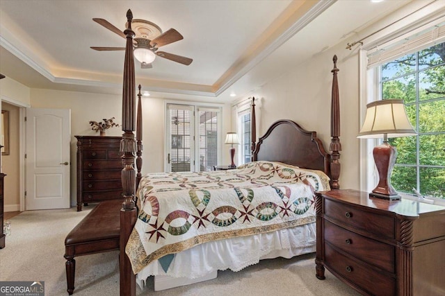 bedroom with a ceiling fan, a raised ceiling, and carpet floors