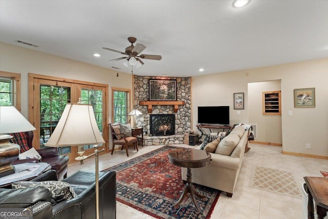 living area featuring a ceiling fan, a stone fireplace, recessed lighting, and visible vents