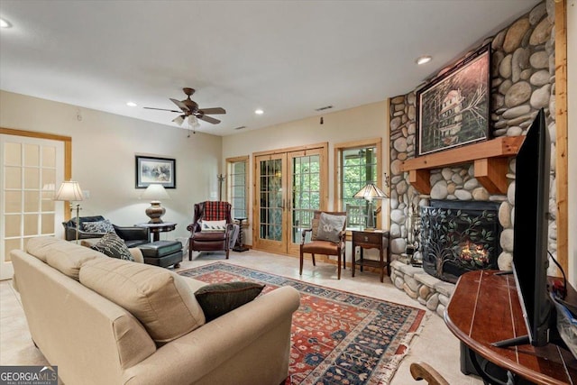 living room with ceiling fan, visible vents, a fireplace, and recessed lighting