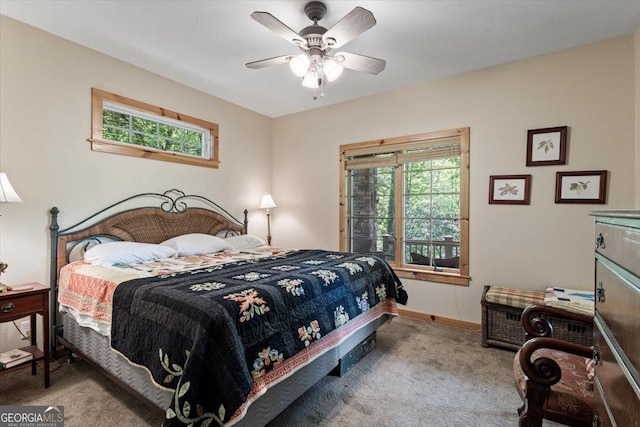 carpeted bedroom with baseboards, a ceiling fan, and multiple windows
