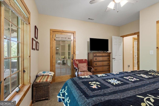 carpeted bedroom with visible vents and a ceiling fan