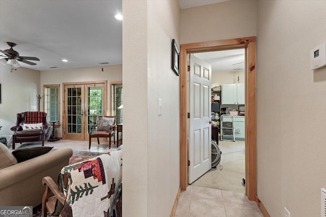 hall featuring baseboards, french doors, light tile patterned floors, and recessed lighting