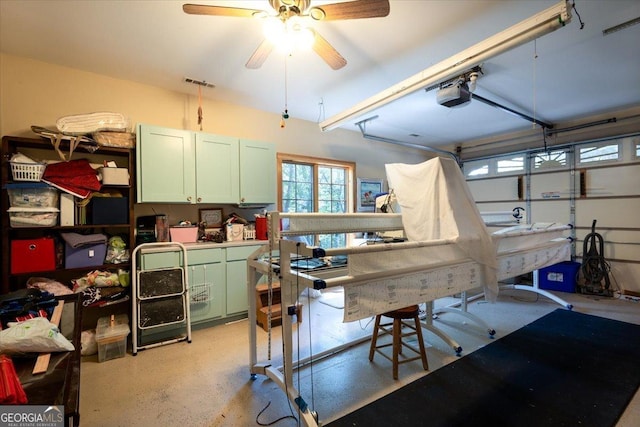garage with ceiling fan, visible vents, and a garage door opener